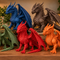Five dragon statues in green, blue, red, brown and orange displayed together on a wooden bookshelf