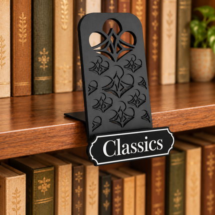 Classics genre sign attached below the black book display shelf at the bookshelf edge. Example colors shown.