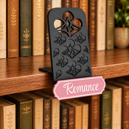 Romance genre sign attached below the black book display shelf at the bookshelf edge. Example colors shown.