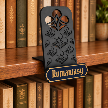 Romantasy genre sign attached below the black book display shelf at the bookshelf edge. Example colors shown.