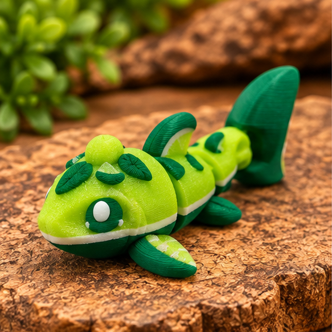Front three-quarter view of Micro Lime Shark miniature on a warm stone display with greenery.
