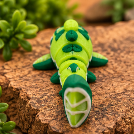 Rear view of Micro Lime Shark miniature on a warm stone display with greenery.