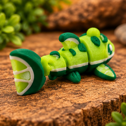 Rear three-quarter view of Micro Lime Shark miniature on a warm stone display with greenery.