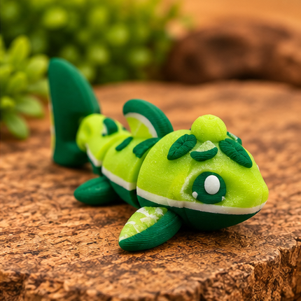 Alternate front view of Micro Lime Shark miniature on a warm stone display with greenery.