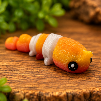 Front three-quarter view of Micro Shrimp miniature on a warm stone display with greenery.