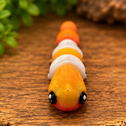 Side view of Micro Shrimp miniature on a warm stone display with greenery.