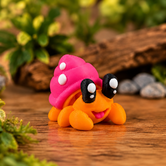 Orange Micro Hermit Crab with pink shell, front view on a wooden surface.