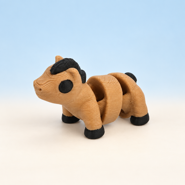 Micro Horse 3D-printed miniature featuring a tan body, dark mane, and dark hooves, on a light surface with a pale blue background.