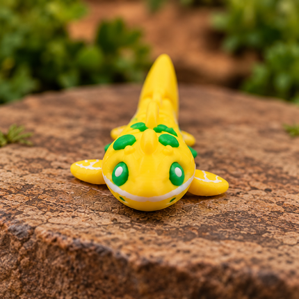 Front view of the Micro Lemon Shark miniature with green eyes and yellow lemon-patterned fins.