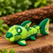 Micro Lime Shark miniature with a lime-green articulated body, dark green fins and white citrus markings, three-quarter view on wood.