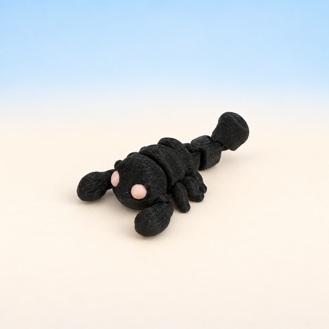 Micro Scorpion 3D-printed miniature featuring a black body, large pincers, and a curved segmented tail, on a light surface with a pale blue background.